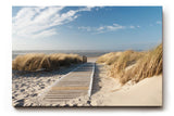 Sinus Art Wandbild 120x80cm Idyllischer Holzsteg durch Dünenlandschaft unter blauem Himmel bis zum Meer