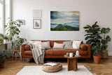 Sinus Art Wandbild 120x80cm Weite grüne Hügel und Berge unter wolkenverhangenem Himmel mit Lichteinfall
