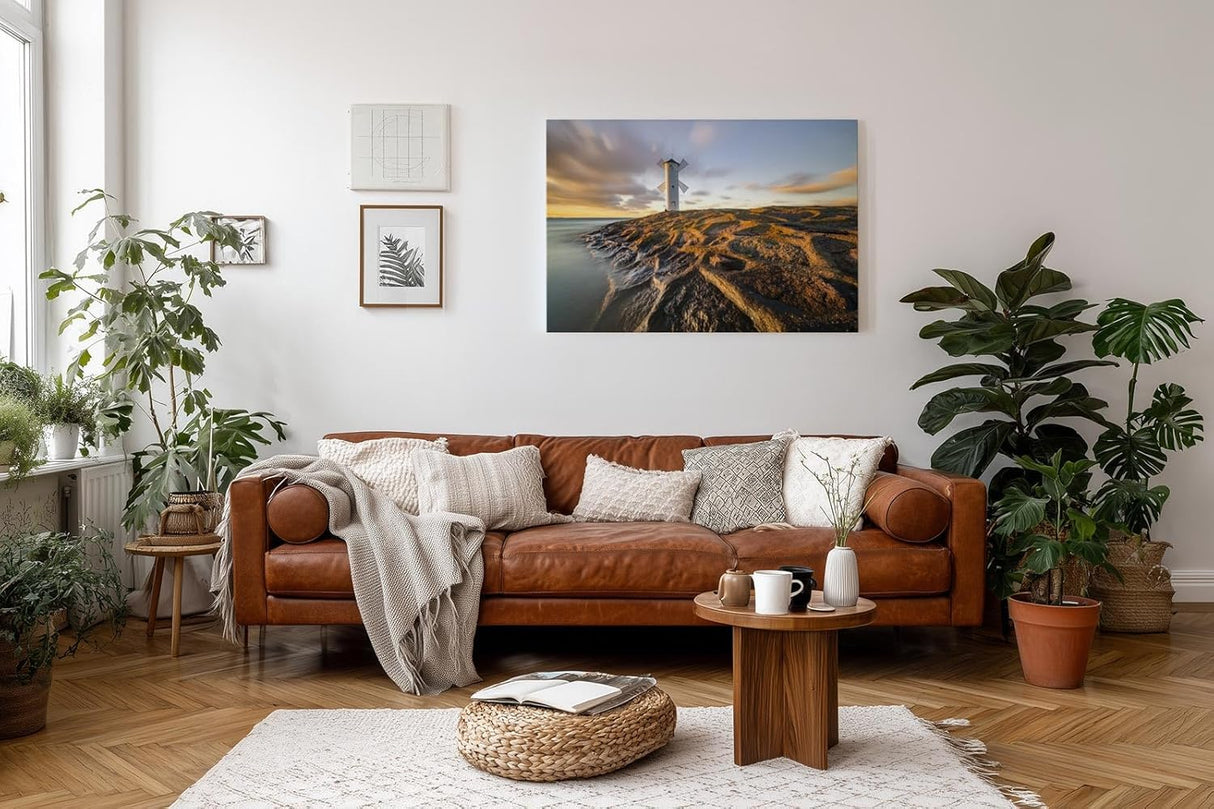 Sinus Art Wandbild 120x80cm Faszinierendes Motiv eines Leuchtturms auf strukturierten Felsen im Abendlicht
