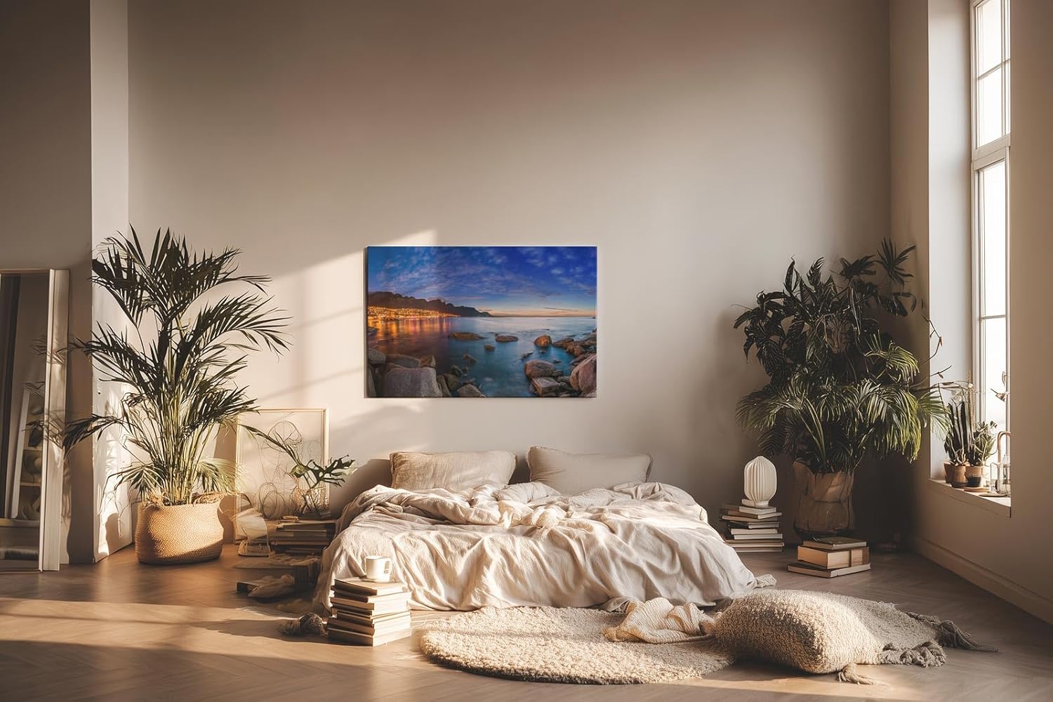 Sinus Art Wandbild 120x80cm Abendliche Szene mit beleuchteter Stadt am Meer, umgeben von Felsen und ruhigem Wasser