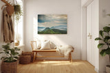 Sinus Art Wandbild 120x80cm Weite grüne Hügel und Berge unter wolkenverhangenem Himmel mit Lichteinfall