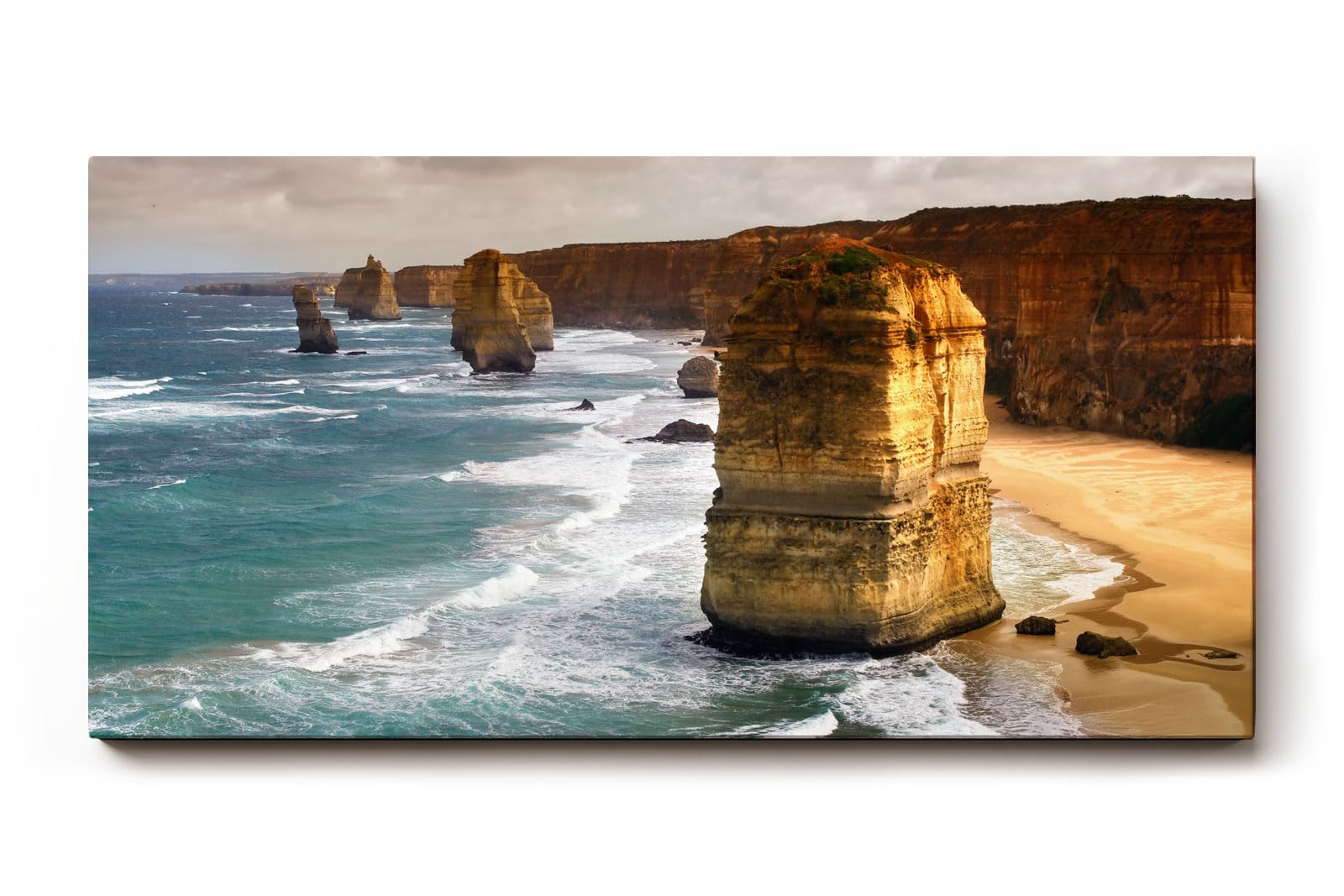 Sinus Art Wandbild 120x80cm Mächtige Sandsteinfelsen umgeben vom Ozean – imposant, dynamisch und zeitlos