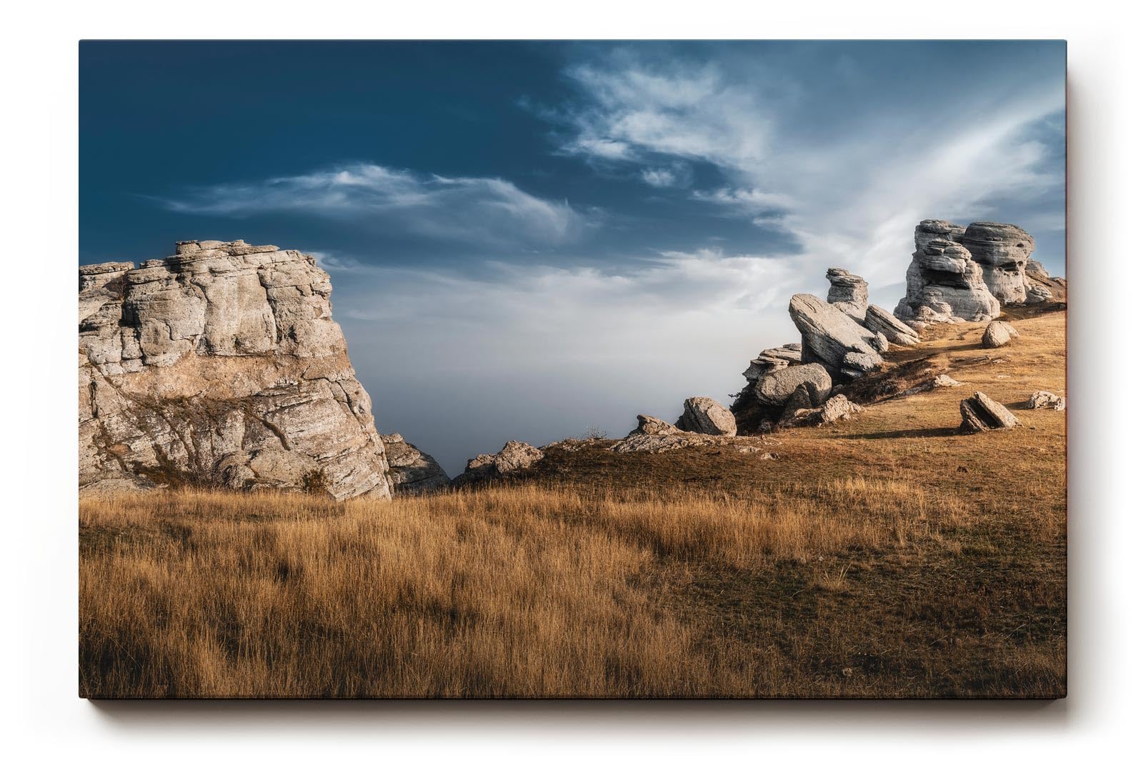 Sinus Art Wandbild 120x80cm Markante Felsformationen unter blauem Himmel in dramatischer Weite
