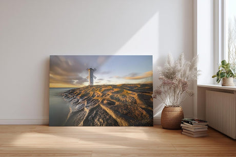 Sinus Art Wandbild 120x80cm Faszinierendes Motiv eines Leuchtturms auf strukturierten Felsen im Abendlicht