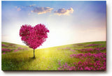Sinus Art Wandbild 120x80cm Herzförmiger Baum in pinker Blüte in weiter Frühlingslandschaft mit Blumenwiese