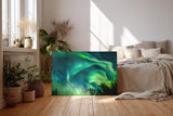 Sinus Art Wandbild 120x80cm Atemberaubende Aurora Borealis mit dynamischem Farbspiel über Silhouetten dunkler Bäume