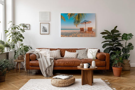 Sinus Art Wandbild 120x80cm Zwei Sonnenliegen am Palmenstrand mit Schirm vor blauem Himmel für entspannte Wirkung