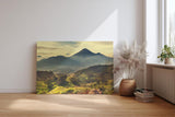 Sinus Art Wandbild 120x80cm Mächtiger Vulkan in weiter Gebirgslandschaft mit grünen Hügeln und aufgehender Sonne