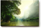 Sinus Art Wandbild 120x80cm Stimmungsvoller Flusslauf im Tal mit Sonnenaufgang und dichter Vegetation