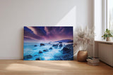 Sinus Art Wandbild 120x80cm Mystische Felsenküste bei Nacht unter violettem Himmel mit leuchtendem Wasser