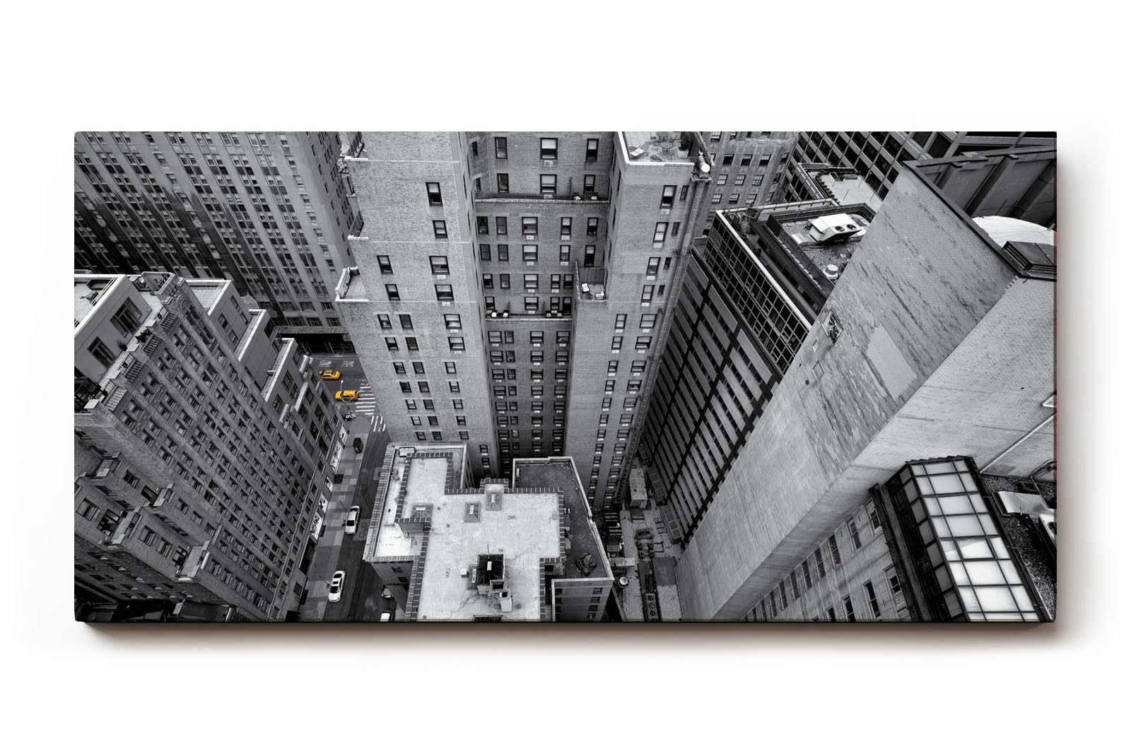 Sinus Art Wandbild 120x80cm Atemberaubende Ansicht einer Metropole aus der Vogelperspektive in Schwarzweiß mit gelben Taxis