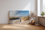 Sinus Art Wandbild 120x80cm Idyllischer Holzsteg durch Dünenlandschaft unter blauem Himmel bis zum Meer