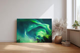 Sinus Art Wandbild 120x80cm Atemberaubende Aurora Borealis mit dynamischem Farbspiel über Silhouetten dunkler Bäume