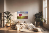 Sinus Art Wandbild 120x80cm Herzförmiger Baum in pinker Blüte in weiter Frühlingslandschaft mit Blumenwiese