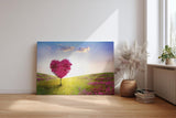 Sinus Art Wandbild 120x80cm Herzförmiger Baum in pinker Blüte in weiter Frühlingslandschaft mit Blumenwiese