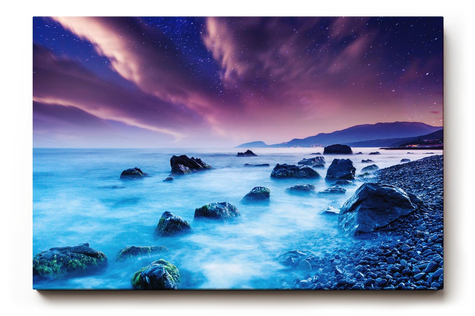 Sinus Art Wandbild 120x80cm Mystische Felsenküste bei Nacht unter violettem Himmel mit leuchtendem Wasser