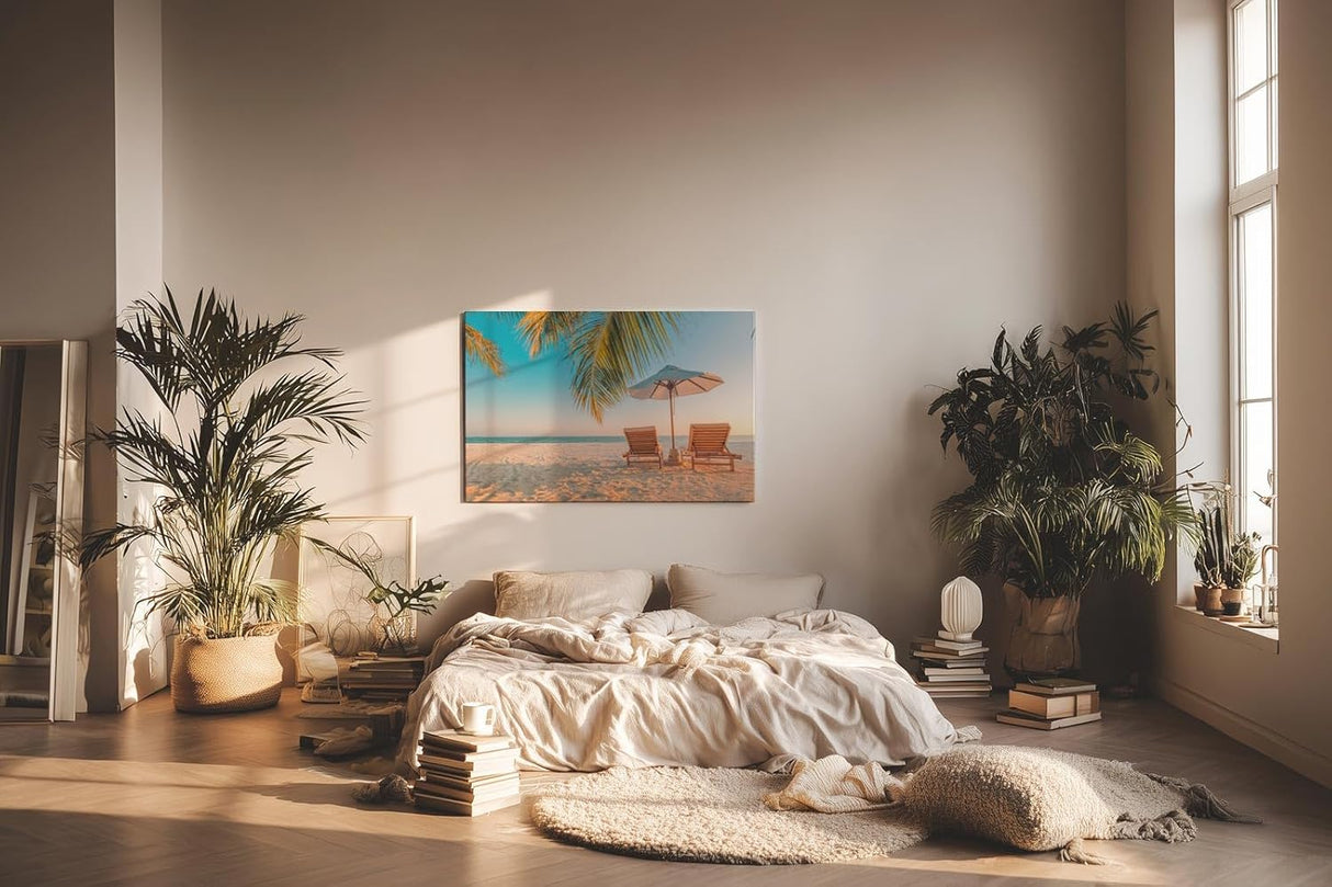 Sinus Art Wandbild 120x80cm Zwei Sonnenliegen am Palmenstrand mit Schirm vor blauem Himmel für entspannte Wirkung
