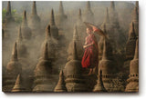 Sinus Art Wandbild 120x80cm Junger Mönch mit Schirm zwischen alten Stupas – Symbol für Glaube und Einkehr