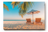Sinus Art Wandbild 120x80cm Zwei Sonnenliegen am Palmenstrand mit Schirm vor blauem Himmel für entspannte Wirkung