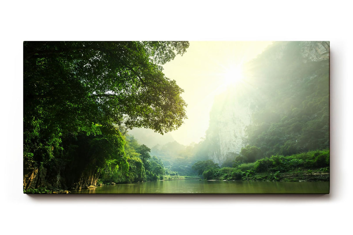 Sinus Art Wandbild 120x80cm Stimmungsvoller Flusslauf im Tal mit Sonnenaufgang und dichter Vegetation